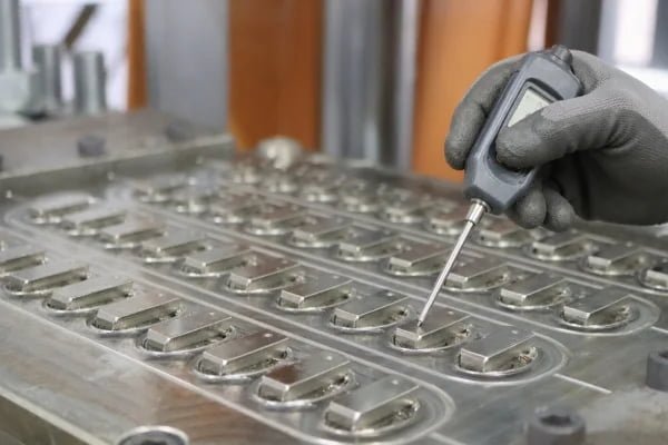 contact thermometer on a mold corner of a silicone rubber press